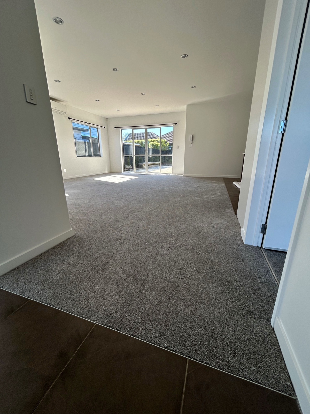 Finished grey carpet in a bright West Auckland lounge
