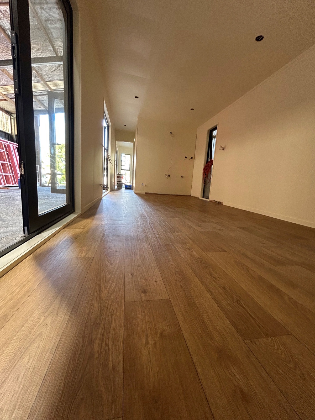 Wood-look vinyl flooring installed in a long room